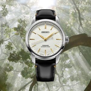 Seiko Presage SPB497 con quadrante in porcellana Arita non smaltata color crema, lancette dorate, cassa in acciaio da 40,6mm e cinturino nero in pelle su sfondo naturale.