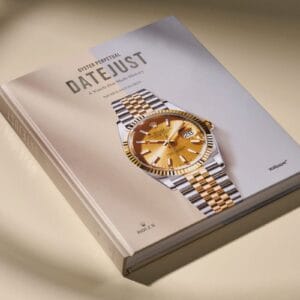 Copertina del libro "Oyster Perpetual Datejust - A Watch that Made History" pubblicato da Rolex in collaborazione con Wallpaper*, che mostra un Datejust con quadrante dorato e bracciale Jubilee in acciaio e oro su sfondo bianco minimalista
