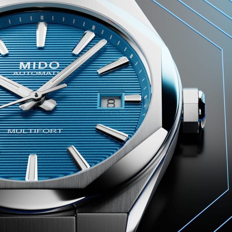Dettaglio macro del quadrante blu intenso con lavorazione a linee orizzontali, indici applicati e datario del Mido Multifort 8 One Crown.