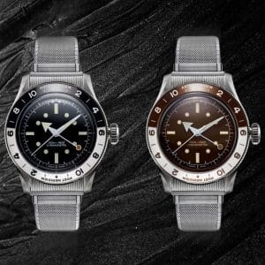 Confronto Serica 8315 GMT: modello con quadrante Nero e nuova versione Desert Red affiancati su sfondo scuro. Entrambi montano il bracciale Bonklip e la lunetta asimmetrica.