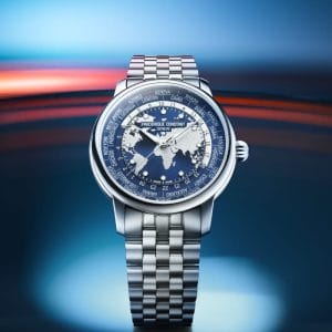 Frederique Constant Classic Worldtimer Manufacture 2026 con bracciale in acciaio a cinque maglie e quadrante blu navy con mappa del mondo in rilievo.